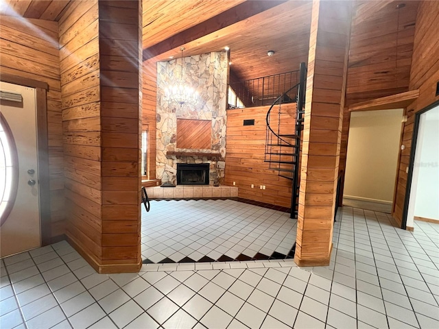 8504 N Campbell Rd, Lakeland, FL 33810 - entryway with light tile patterned floors, wood walls, and an outdoor stone fireplace