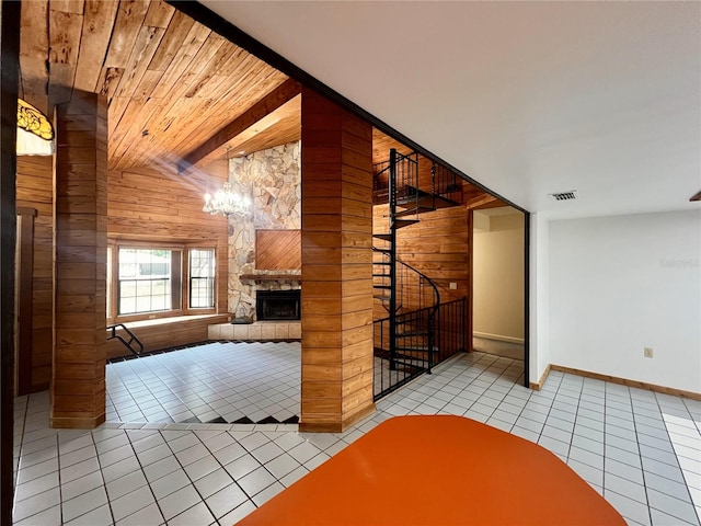 8504 N Campbell Rd, Lakeland, FL 33810 - unfurnished living room with wooden walls, light tile patterned floors, baseboards, a fireplace, and a chandelier