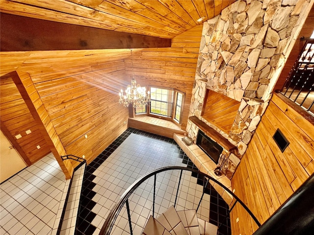 8504 N Campbell Rd, Lakeland, FL 33810 - stairs with wood walls, tile patterned flooring, a chandelier, wood ceiling, and lofted ceiling