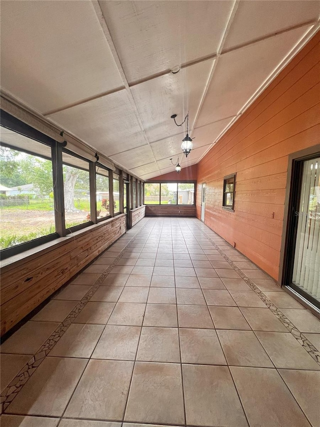 8504 N Campbell Rd, Lakeland, FL 33810 - unfurnished sunroom with wooden walls, lofted ceiling, and tile patterned floors