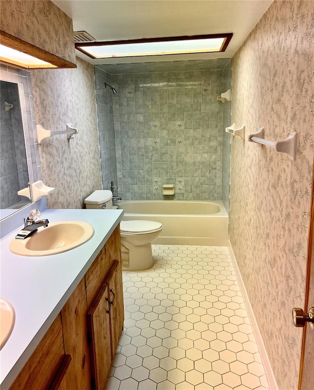 8504 N Campbell Rd, Lakeland, FL 33810 - bathroom with double vanity,  shower combination, toilet, tile patterned flooring, and baseboards