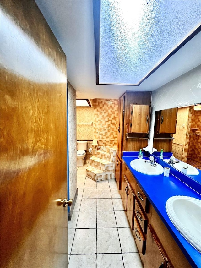 8504 N Campbell Rd, Lakeland, FL 33810 - full bath with double vanity, toilet, and tile patterned floors