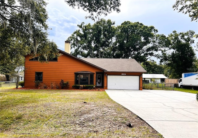 8504 N Campbell Rd, Lakeland, FL 33810 - view of front of home featuring a garage, driveway, and a chimney