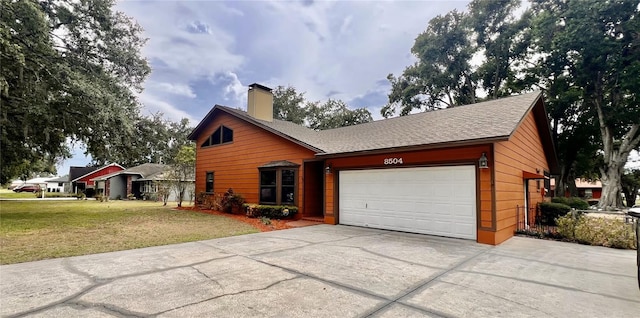 8504 N Campbell Rd, Lakeland, FL 33810 - view of front of home with concrete driveway, a garage, a front lawn, and a chimney