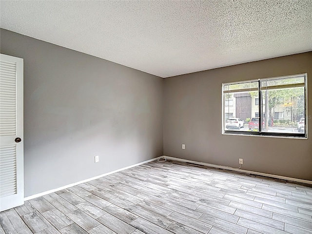 11704 Raintree Village Blvd Unit B, Temple Terrace, FL 33617 - unfurnished room featuring light wood-type flooring and a textured ceiling