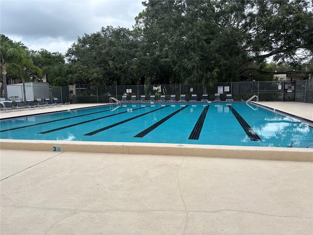 11704 Raintree Village Blvd Unit B, Temple Terrace, FL 33617 - community pool with a patio area and view of wooded area