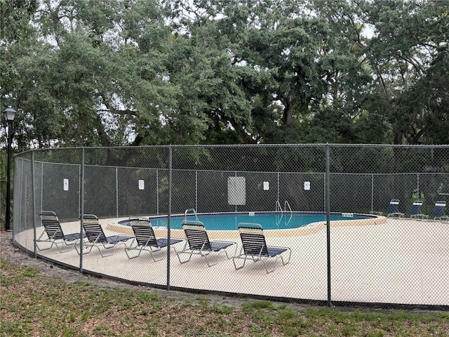 11704 Raintree Village Blvd Unit B, Temple Terrace, FL 33617 - community pool with a patio area and view of scattered trees
