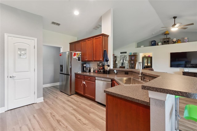 1531 Blue Sky Blvd, Haines City, FL 33844 - kitchen featuring appliances with stainless steel finishes, dark countertops, a peninsula, vaulted ceiling, and ceiling fan