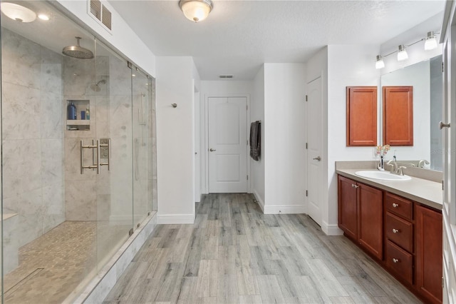 1531 Blue Sky Blvd, Haines City, FL 33844 - full bathroom featuring a shower stall, vanity, and wood finished floors