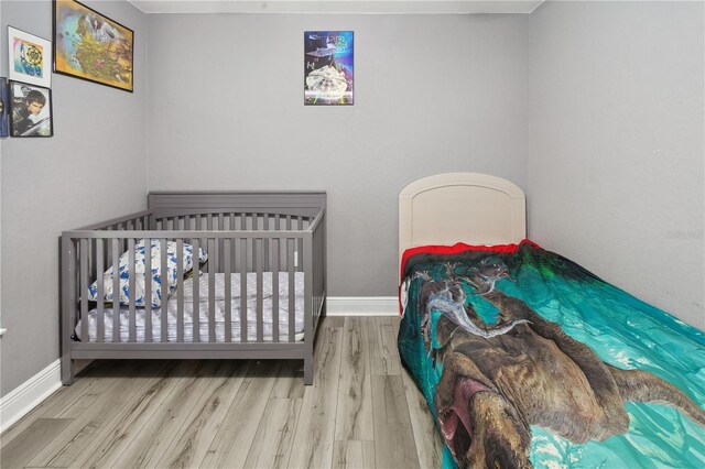 1531 Blue Sky Blvd, Haines City, FL 33844 - bedroom featuring wood finished floors and baseboards