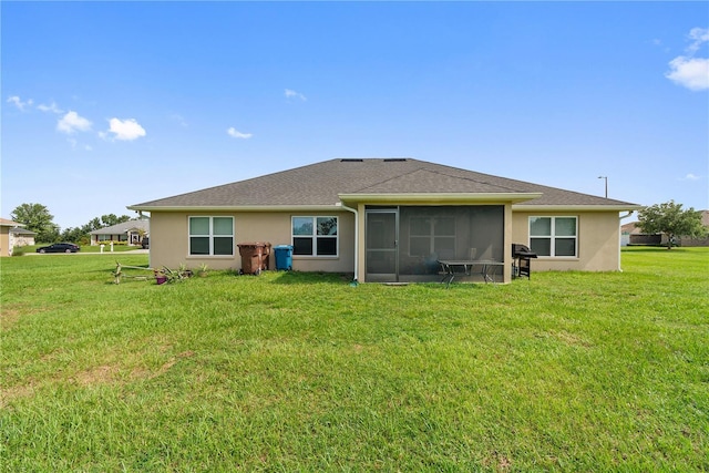 1531 Blue Sky Blvd, Haines City, FL 33844 - back of property featuring a sunroom, a lawn, and stucco siding