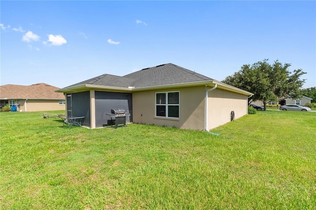 1531 Blue Sky Blvd, Haines City, FL 33844 - rear view of property featuring a yard, stucco siding, and a sunroom