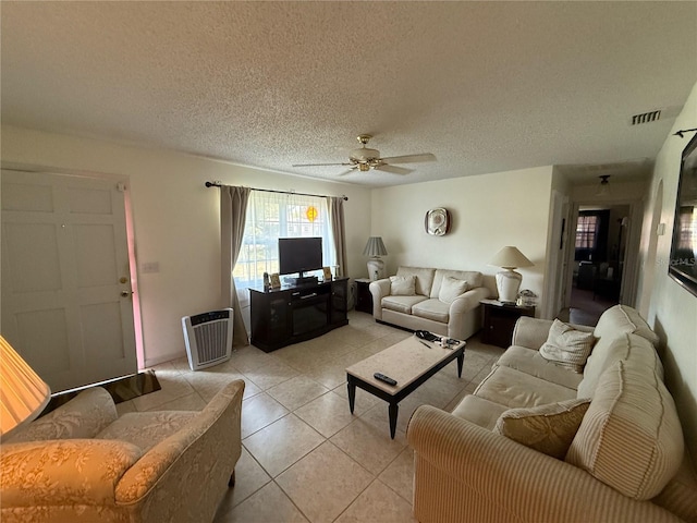 2424 Bates Ave SW, Winter Haven, FL 33880 - living room with a ceiling fan, light tile patterned floors, and a textured ceiling
