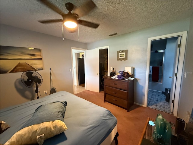 2424 Bates Ave SW, Winter Haven, FL 33880 - bedroom with light carpet, a textured ceiling, a ceiling fan, and connected bathroom