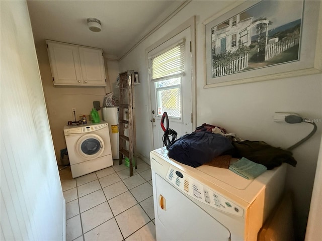 2424 Bates Ave SW, Winter Haven, FL 33880 - laundry room featuring water heater, cabinet space, and light tile patterned flooring