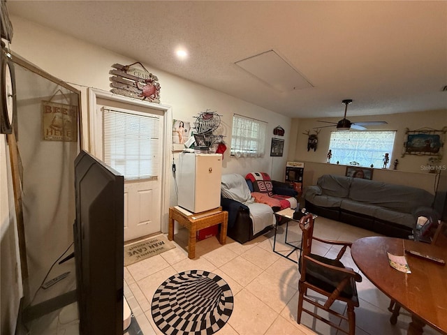 2424 Bates Ave SW, Winter Haven, FL 33880 - living area with light tile patterned floors, a ceiling fan, and attic access