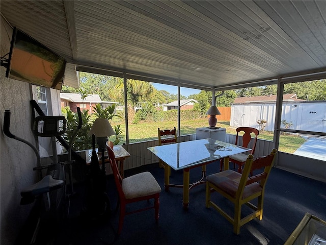 2424 Bates Ave SW, Winter Haven, FL 33880 - sunroom / solarium featuring outdoor dining area, wood ceiling, and carpet flooring