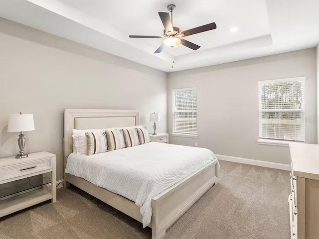 828 Cypress Creek Run, Saint Cloud, FL 34771 - carpeted bedroom featuring a tray ceiling, baseboards, and ceiling fan
