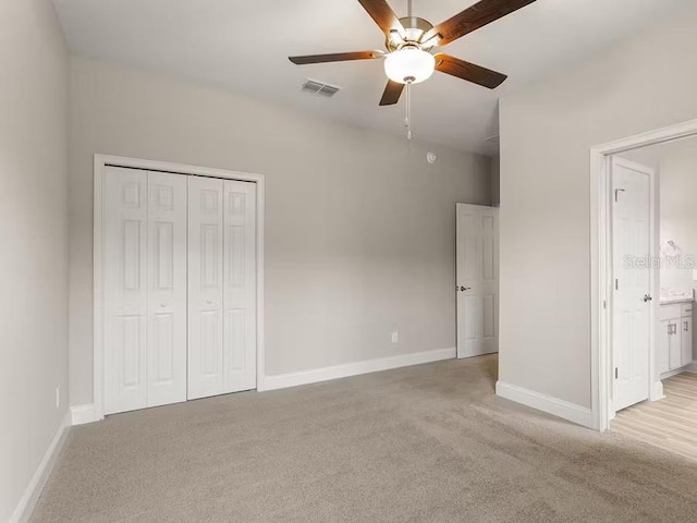 828 Cypress Creek Run, Saint Cloud, FL 34771 - unfurnished bedroom with light colored carpet, baseboards, a closet, and a ceiling fan