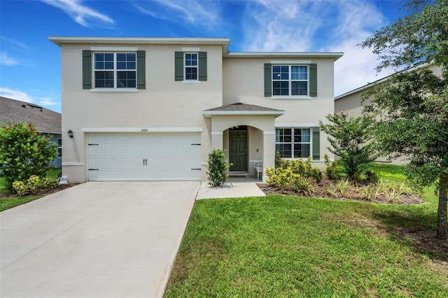 3685 Diving Dove Ln, Bartow, FL 33830 - traditional-style house with an attached garage, stucco siding, concrete driveway, and a front lawn