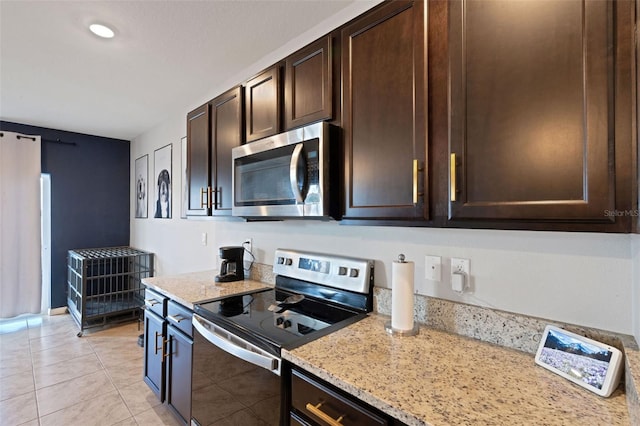 3685 Diving Dove Ln, Bartow, FL 33830 - kitchen with appliances with stainless steel finishes, dark brown cabinetry, light stone countertops, and light tile patterned floors