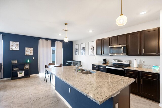 3685 Diving Dove Ln, Bartow, FL 33830 - kitchen featuring appliances with stainless steel finishes, light stone countertops, hanging light fixtures, light tile patterned flooring, and dark brown cabinets