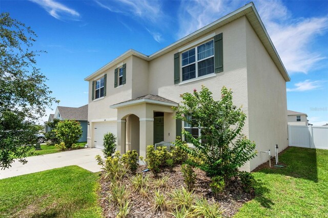 3685 Diving Dove Ln, Bartow, FL 33830 - traditional-style house with an attached garage, stucco siding, and concrete driveway