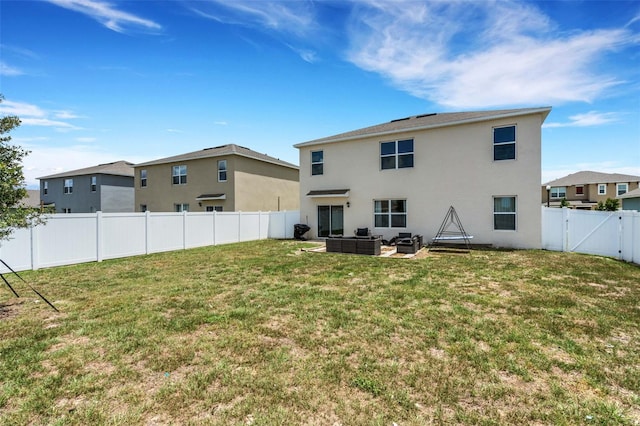 3685 Diving Dove Ln, Bartow, FL 33830 - rear view of house featuring stucco siding, a fenced backyard, outdoor lounge area, a gate, and a patio area