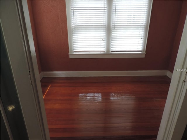 701 E Lime St, Lakeland, FL 33801 - unfurnished room with wood finished floors, baseboards, and healthy amount of natural light