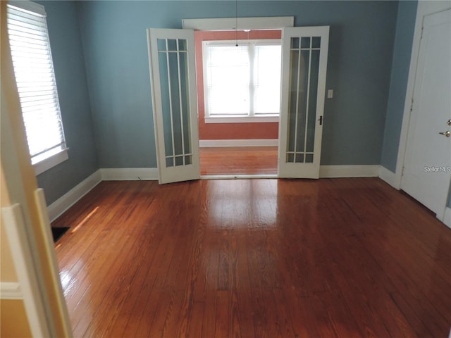 701 E Lime St, Lakeland, FL 33801 - unfurnished room with french doors, hardwood / wood-style floors, baseboards, and plenty of natural light