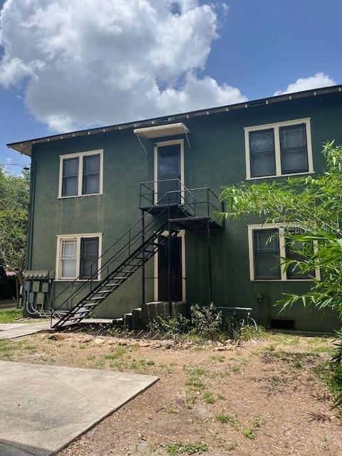 701 E Lime St, Lakeland, FL 33801 - rear view of property with stairs and stucco siding