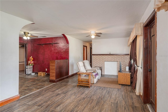 114 Pennsylvania Ave, Wauchula, FL 33873 - living area with a ceiling fan, wood finished floors, a fireplace, and arched walkways