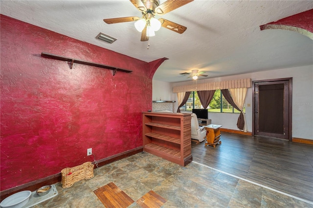 114 Pennsylvania Ave, Wauchula, FL 33873 - living area with a ceiling fan, a textured ceiling, and stone finish flooring