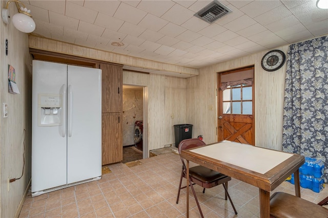 114 Pennsylvania Ave, Wauchula, FL 33873 - dining space with light tile patterned flooring, wallpapered walls, and wood walls