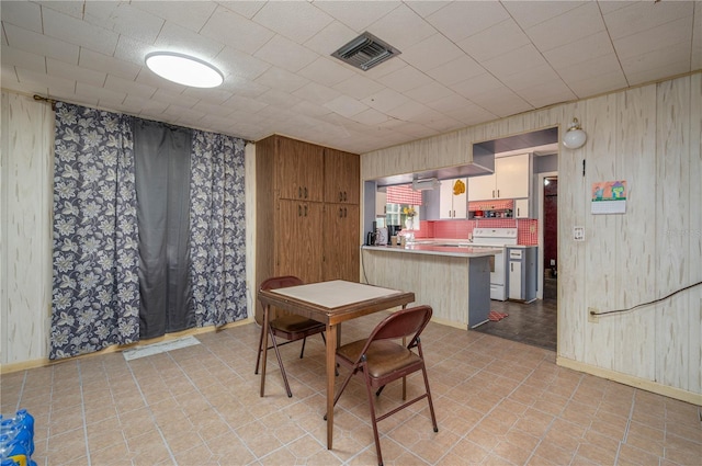114 Pennsylvania Ave, Wauchula, FL 33873 - dining space with baseboards and wooden walls