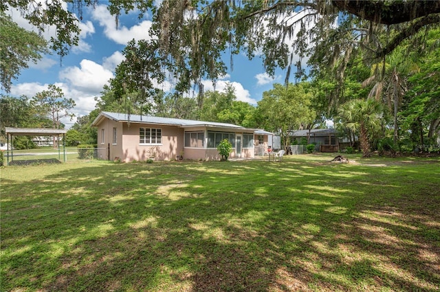 114 Pennsylvania Ave, Wauchula, FL 33873 - back of property featuring a fenced backyard and a sunroom