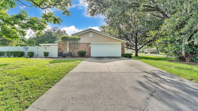1910 Clubhouse Rd, Lakeland, FL 33813 - view of front of property featuring brick siding, concrete driveway, central AC, and a garage