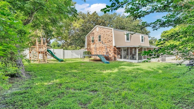 1910 Clubhouse Rd, Lakeland, FL 33813 - back of house with a sunroom, brick siding, and a playground