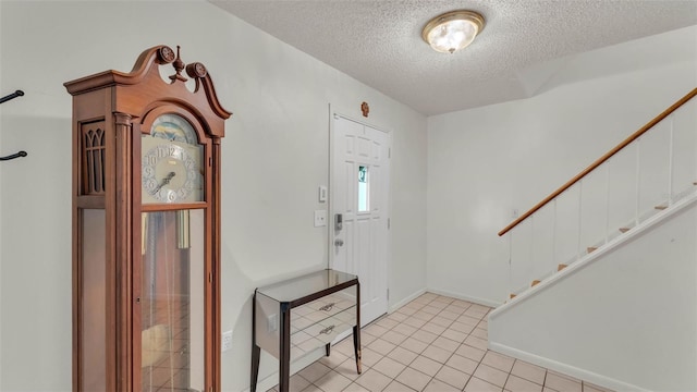 1910 Clubhouse Rd, Lakeland, FL 33813 - entryway with a textured ceiling, stairway, light tile patterned floors, and baseboards