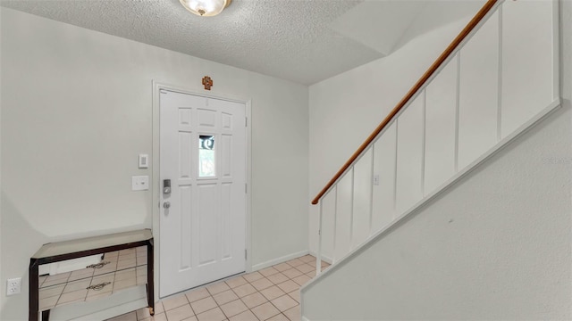 1910 Clubhouse Rd, Lakeland, FL 33813 - entryway with stairs, a textured ceiling, light tile patterned floors, and baseboards