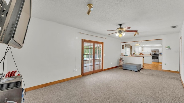 1910 Clubhouse Rd, Lakeland, FL 33813 - unfurnished living room with baseboards, light colored carpet, ceiling fan, and a textured ceiling