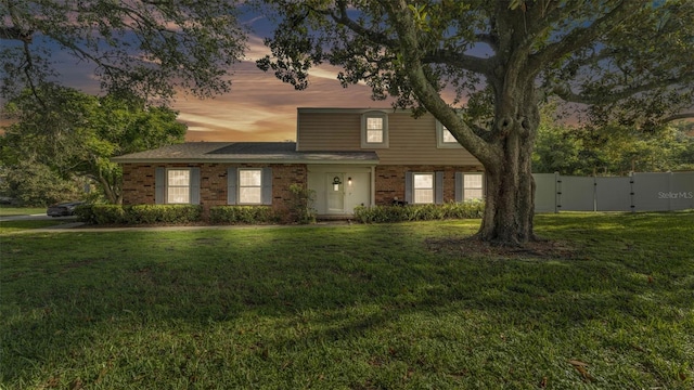 1910 Clubhouse Rd, Lakeland, FL 33813 - traditional-style home featuring brick siding and a gate
