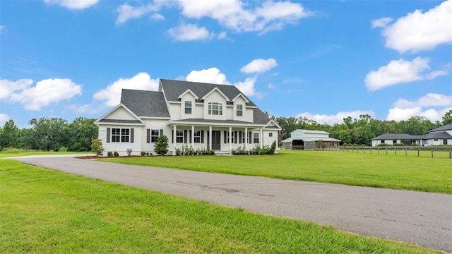 1385 Ewell Rd, Lakeland, FL 33811 - traditional-style home featuring roof with shingles and covered porch