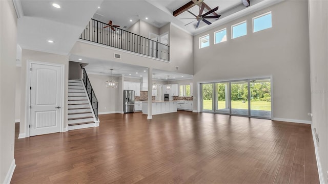 1385 Ewell Rd, Lakeland, FL 33811 - unfurnished living room with ceiling fan, stairs, a high ceiling, recessed lighting, and beamed ceiling