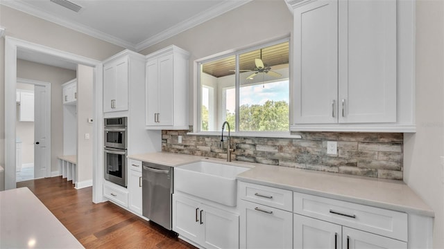 1385 Ewell Rd, Lakeland, FL 33811 - kitchen featuring stainless steel appliances, light countertops, white cabinetry, decorative backsplash, and a ceiling fan