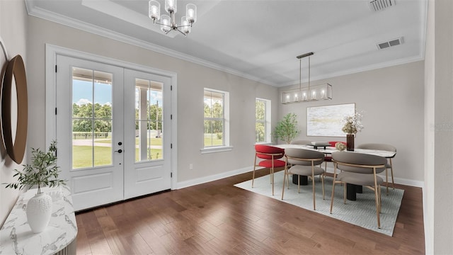 1385 Ewell Rd, Lakeland, FL 33811 - dining space featuring french doors, a chandelier, ornamental molding, and wood finished floors