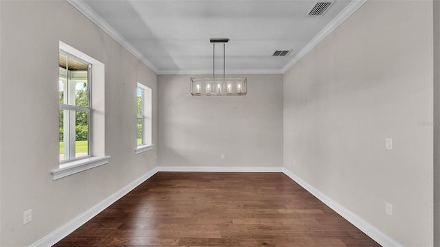 1385 Ewell Rd, Lakeland, FL 33811 - spare room featuring ornamental molding, dark wood-type flooring, and a chandelier