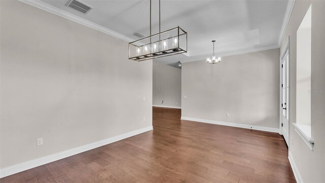 1385 Ewell Rd, Lakeland, FL 33811 - spare room with a chandelier, wood finished floors, and ornamental molding