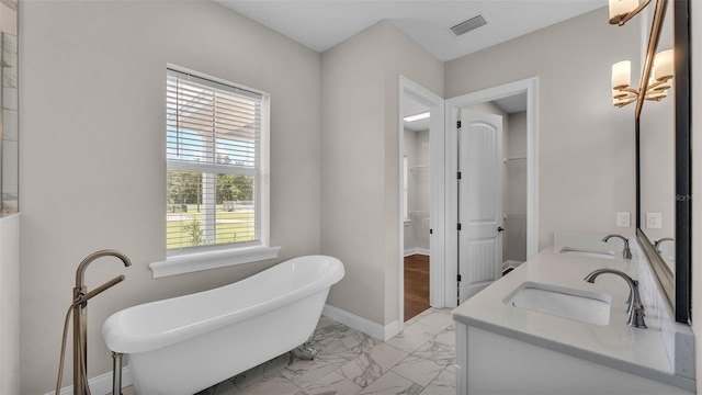 1385 Ewell Rd, Lakeland, FL 33811 - full bathroom with a walk in closet, marble finish flooring, a freestanding bath, and double vanity