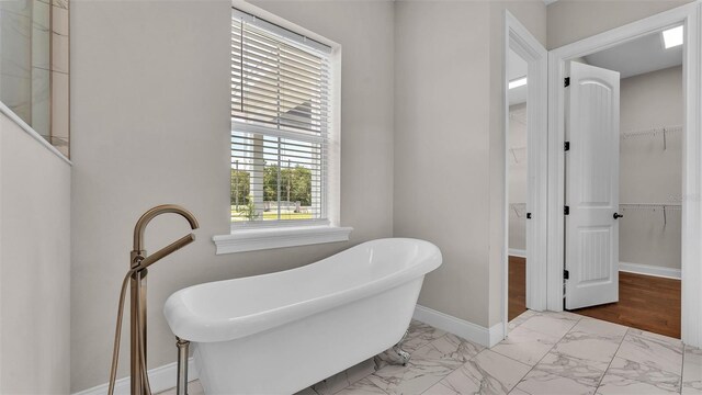 1385 Ewell Rd, Lakeland, FL 33811 - living area with marble look tile flooring and baseboards